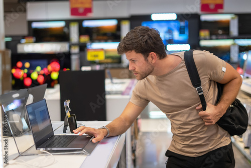 Man exploring new gadget in e store