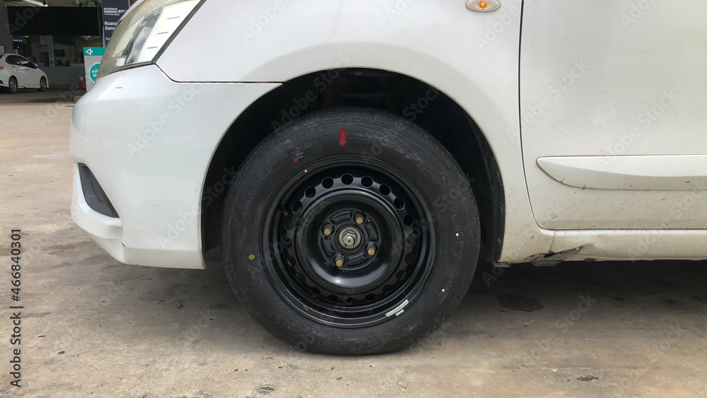 Close up image of car wheel with black rubber tire