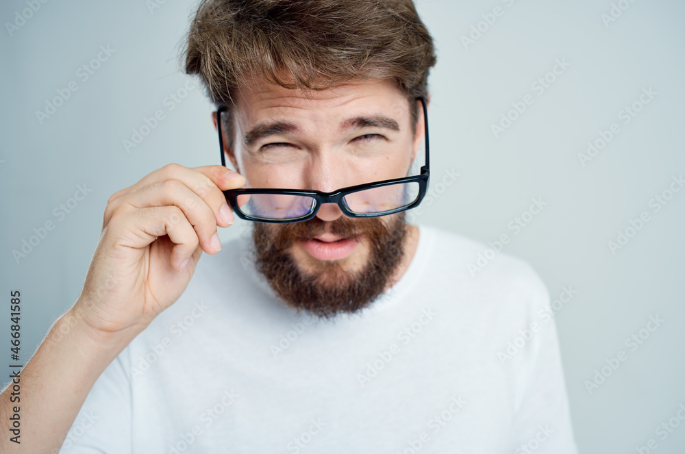 man vision problems in white t-shirt isolated background