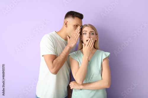Gossiping young couple on c...