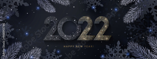 Happy New Year 2022 beautiful sparkling design of numbers on Dark elegant background with frame made of black snowflakes in paper cut style, beautiful fir branches and shining glitter. Minimal design.