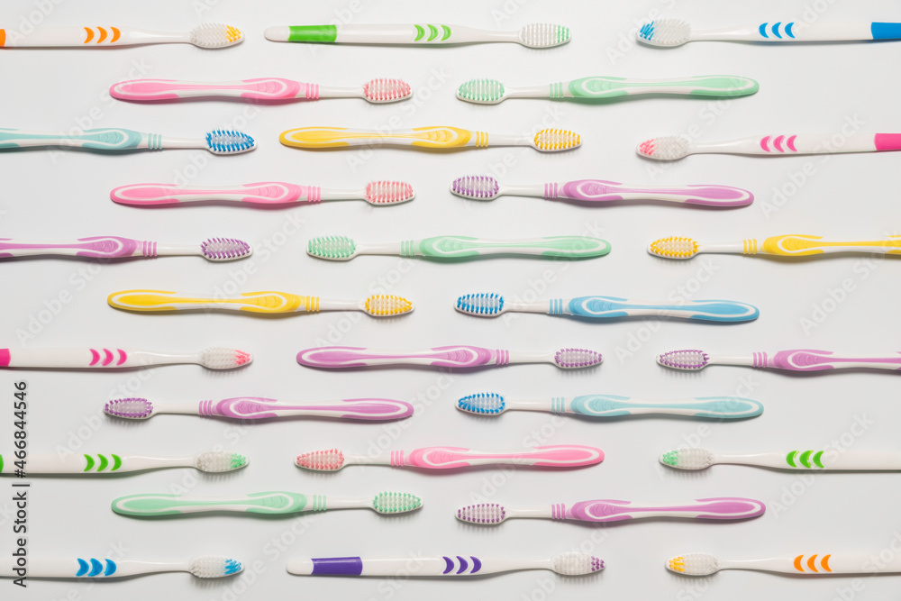 Top view of toothbrushes in colorful on pastel color background.