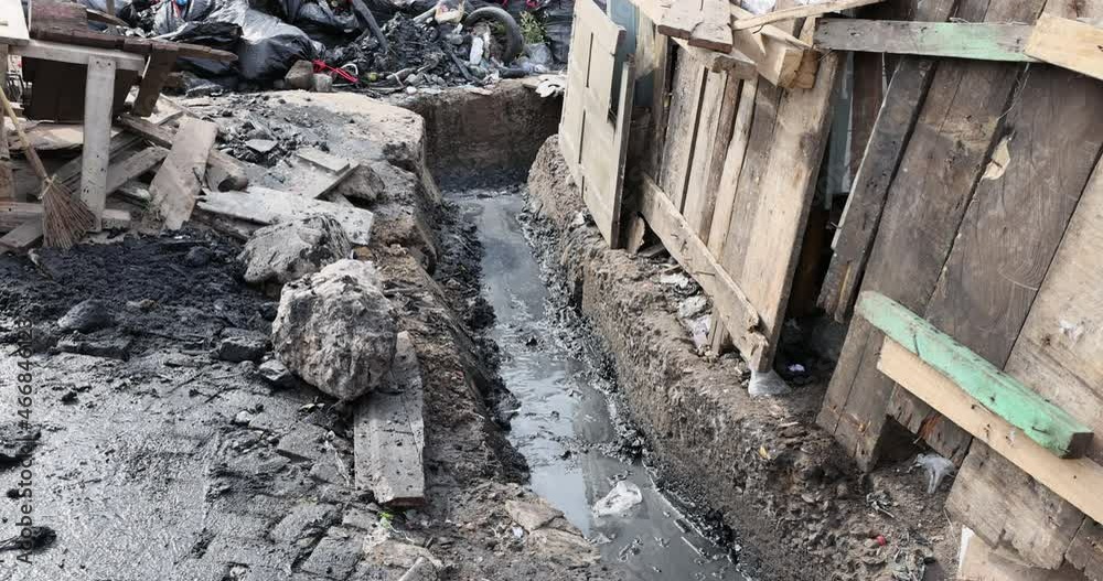 Trash garbage sewer ditch drain poverty area Accra Ghana. Historical busy congested market residential area Accra, Ghana. Pollution and garbage. Homes low income poverty of Africa. Trash garbage sewer ditch drain poverty area Accra Ghana. Historical busy congested market residential area Accra, Ghana. Pollution and garbage. Homes low income poverty of Africa.