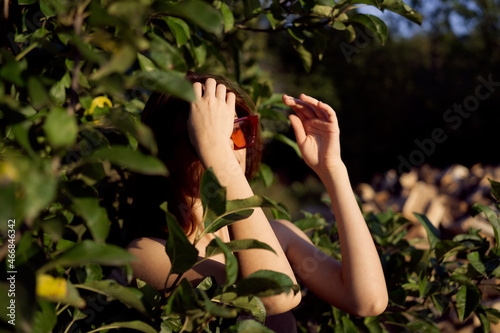 attractive woman summer outdoors green leaves fashion