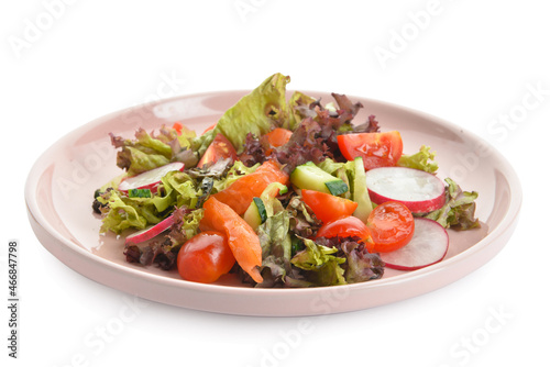 Delicious salad with salmon and vegetables in plate on white background