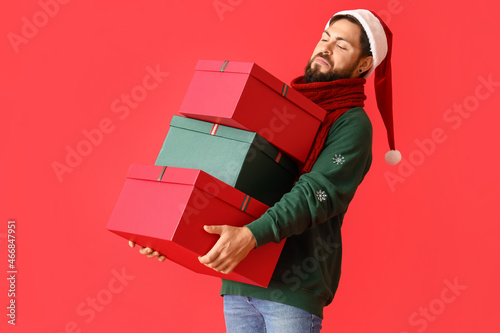 Handsome man in Santa hat w...