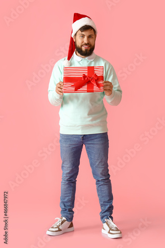 Handsome man in Santa hat w...