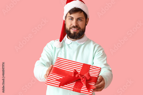 Handsome man in Santa hat w...