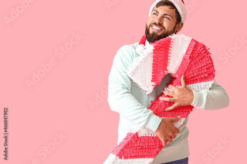 Handsome man in Santa hat w...