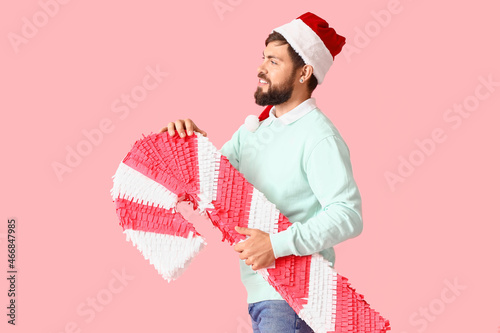 Handsome man in Santa hat w...
