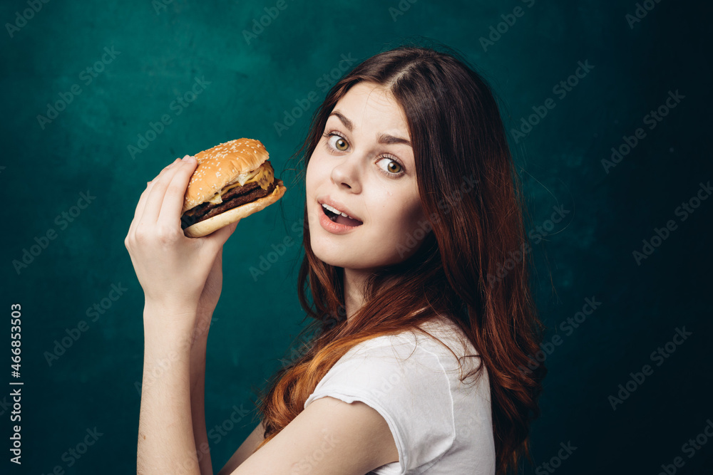 cheerful woman eating hamburger snack close-up lifestyle cheerful woman eating hamburger snack close-up lifestyle