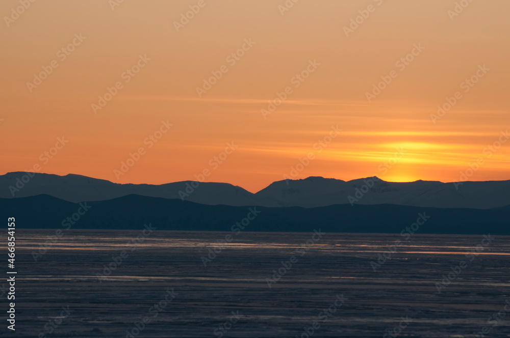 sunset over frozen lake Baikal 