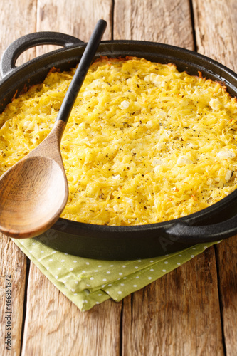 Patatnik is a delicious Bulgarian potato pie with cheese, mint and eggs close-up on the wooden table. Vertical photo