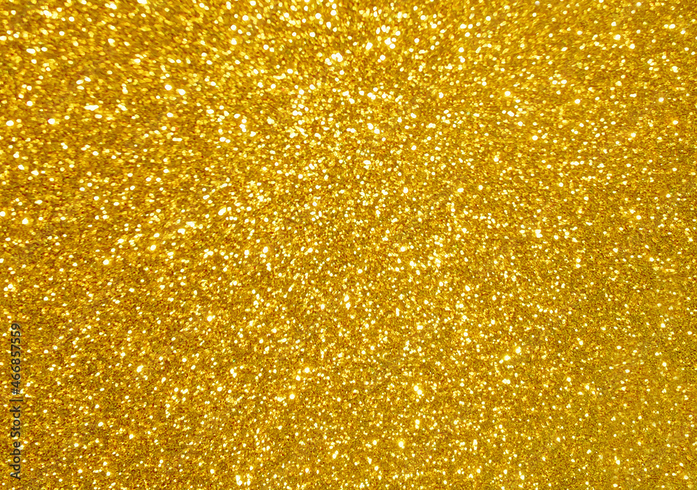 Golden yellow glitter bokeh background.  Photo can be used for New Year, Christmas and all celebration concepts.