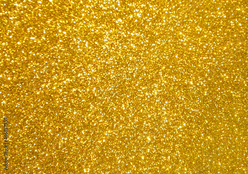 Golden yellow glitter bokeh background.  Photo can be used for New Year, Christmas and all celebration concepts.