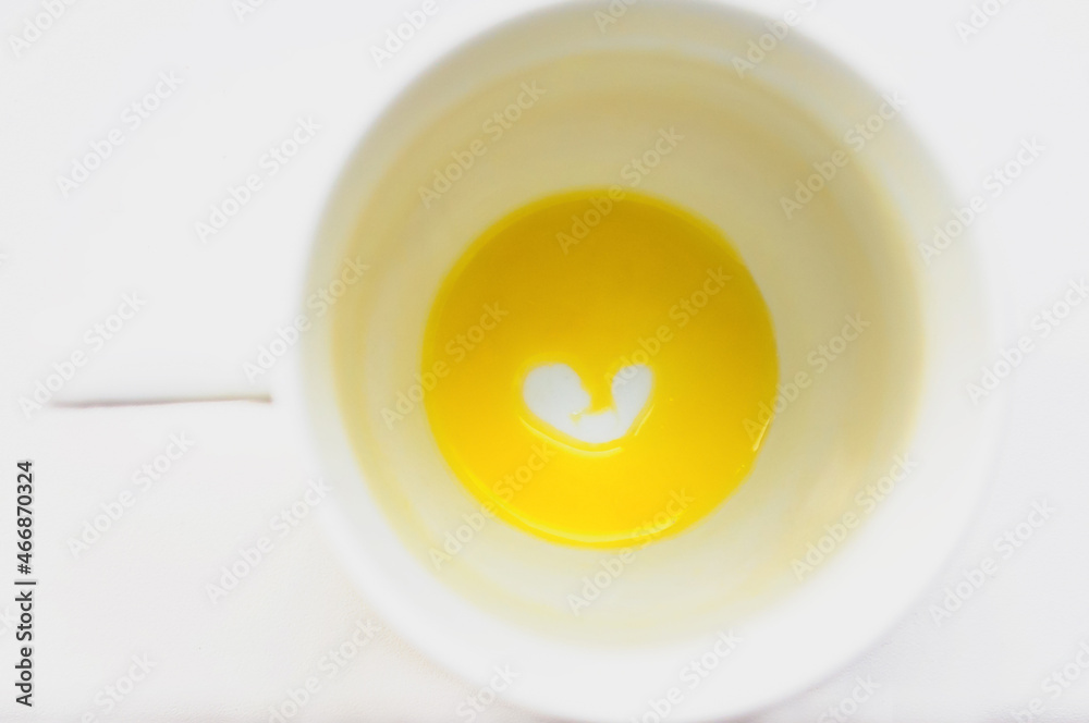 White cup with orange juice heart on a white background. Declaration of love. Valentine's day card White cup with orange juice heart on a white background. Declaration of love. Valentine's day card
