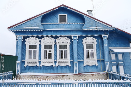 Vintage wooden rural house in Dunilovo village in Ivanovo region, Russia. Building facade; ornamental windows with carved frames. Russian traditional national folk style in architecture. Countryside photo