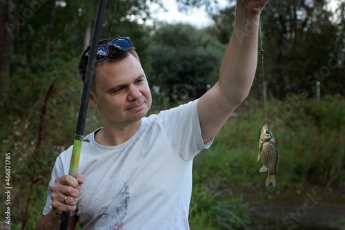 Portrait of adult man fishing with rods in early spring day, family weekend concept, outdoor photo