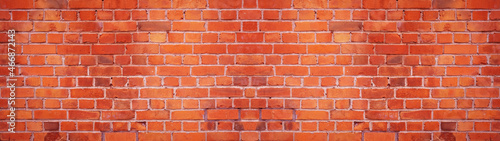 Orange red damaged rustic brick wall brickwork stonework masonry texture background banner panorama.