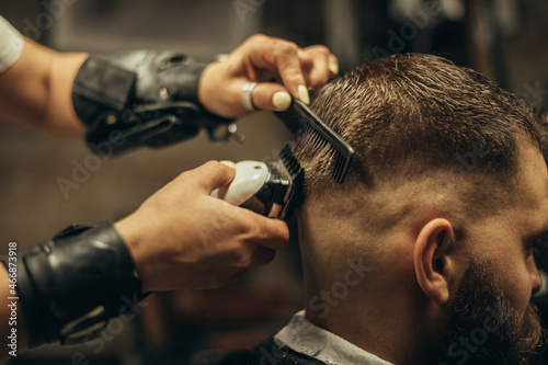 Young bearded man getting haircut by hairdresser © Zamrznuti tonovi