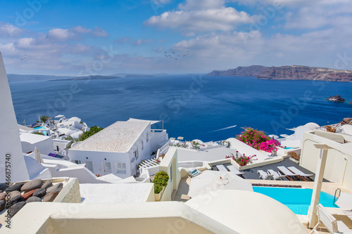 Beautiful Santorini landscape with white architecture and sea view. Sunny summer travel background  cityscape  urban scenic. Idyllic streets  pathway  pool and houses. Luxury resort hotel vacation