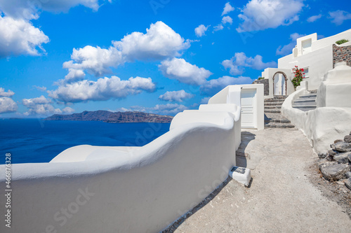 Oia town on Santorini island, Greece. Traditional famous white blue houses stairs, pathways under sunny blue sky Caldera, Aegean sea. Beautiful summer landscape, sea view, luxury travel vacation