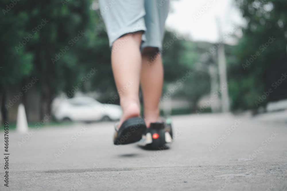 Blur background small child legs playing scooter