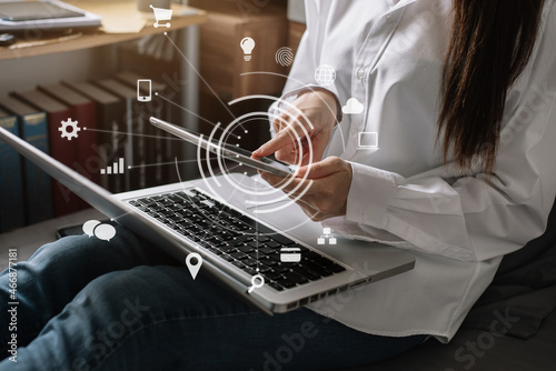Female clicking internet search page on computer and tablet touch screen in the home.