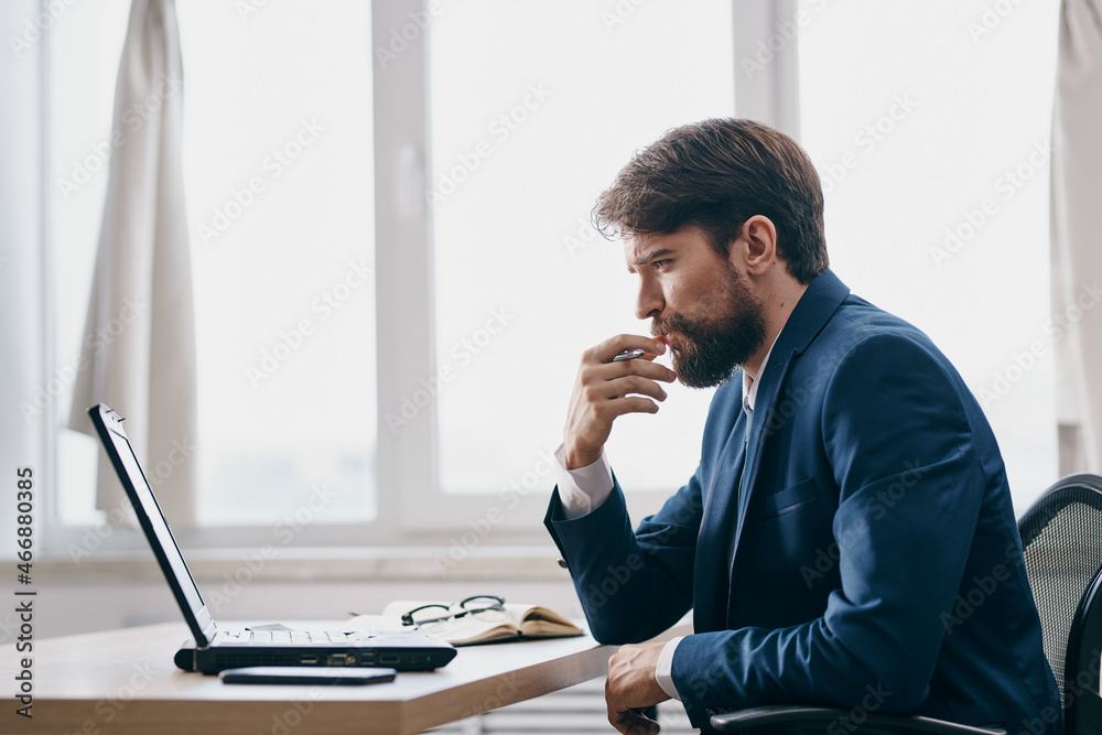 man in front of laptop in the office in front of a laptop executive manager man in front of laptop in the office in front of a laptop executive manager