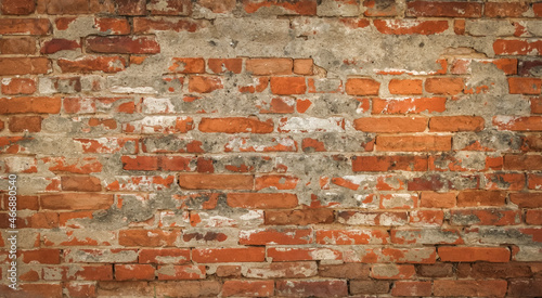 Old rustical brick wall with peeling plaster