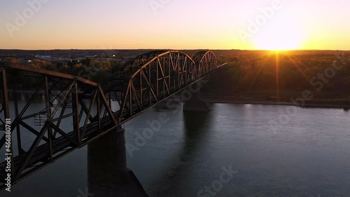Flying along historic old railroad bridge in North Dakota at sunset over the Missouri River near Bismarck. photo