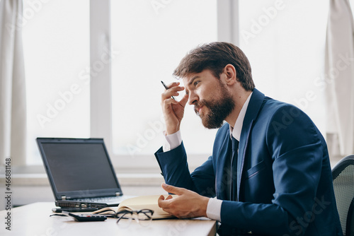 businessmen working for a laptop in the office emotions discontent official