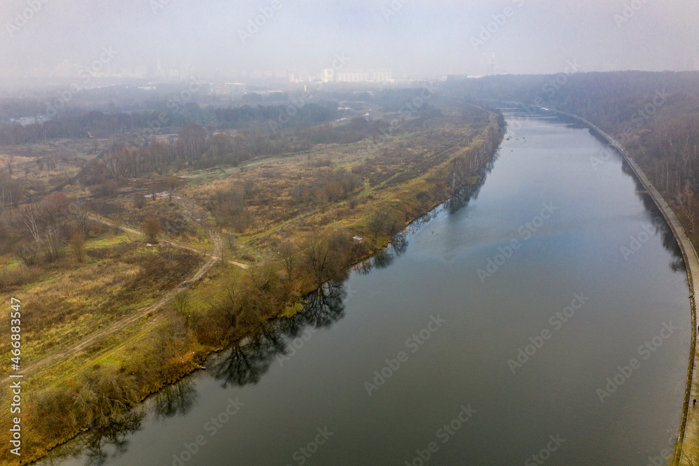 autumn green river and yellow park on a cloudy autumn day filmed from a drone 
