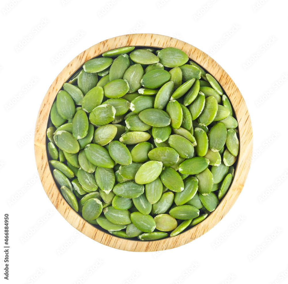 Pumpkin seeds green peeled in wooden bowl isolated on white background. Pumpkin seeds green peeled in wooden bowl isolated on white background.