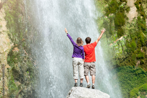 Happy couple enjoying a waterfall