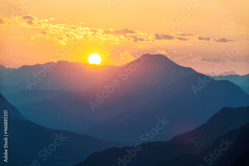 Sun setting behind mountains