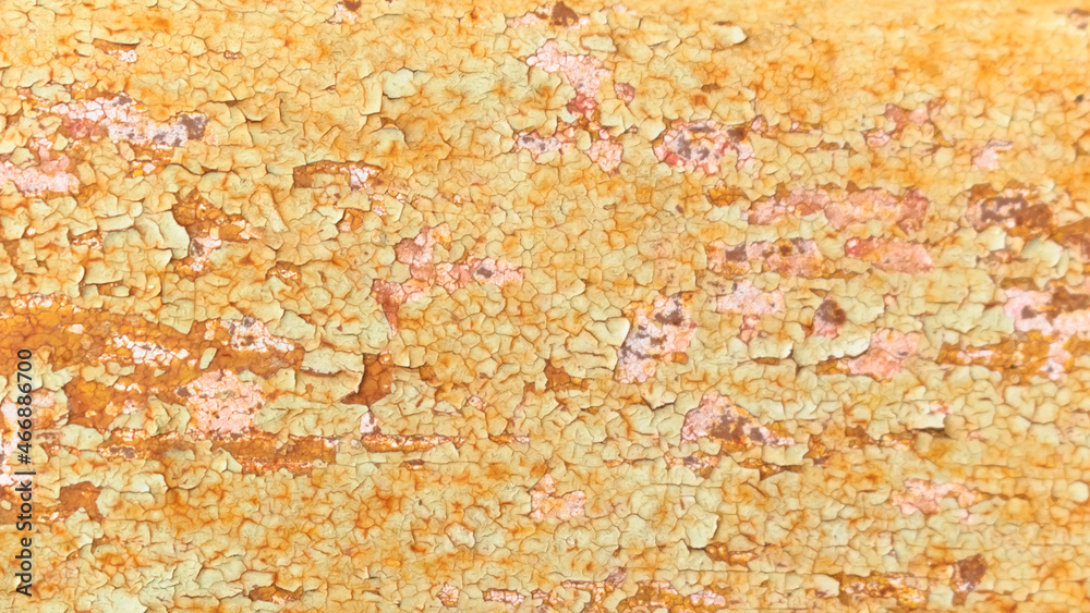The texture of a rusty metal structure with peeling old paint