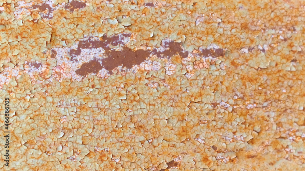 The texture of a rusty metal structure with peeling old paint