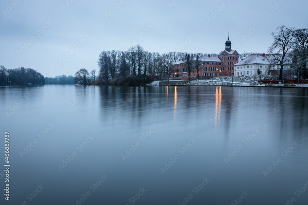 Castle of Eutin on winter day with reflections on water, Schleswig-Holstein, Germany