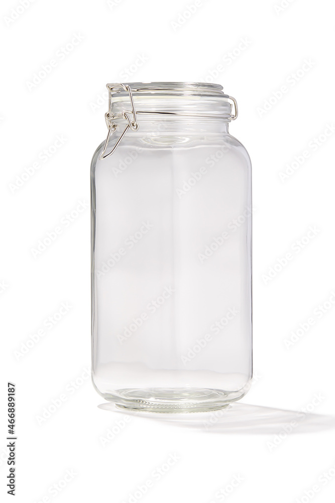 Detailed shot of a glass jar. Kitchen tableware is transparent. The jar with lid is isolated on the white background. Detailed shot of a glass jar. Kitchen tableware is transparent. The jar with lid is isolated on the white background.