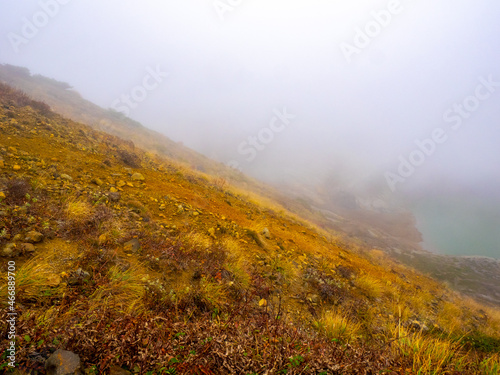 Slope running into a caldera lake in a fog (Zao, Katta-gun, Miyagi, Japan) © Mayumi.K.Photography