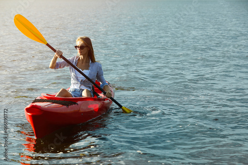 Beautiful woman kayaking on river, space for text. Summer activity © New Africa