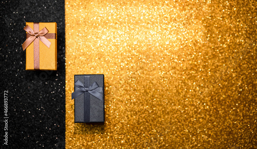 black and gold box on gold background with glitter. black friday. photo