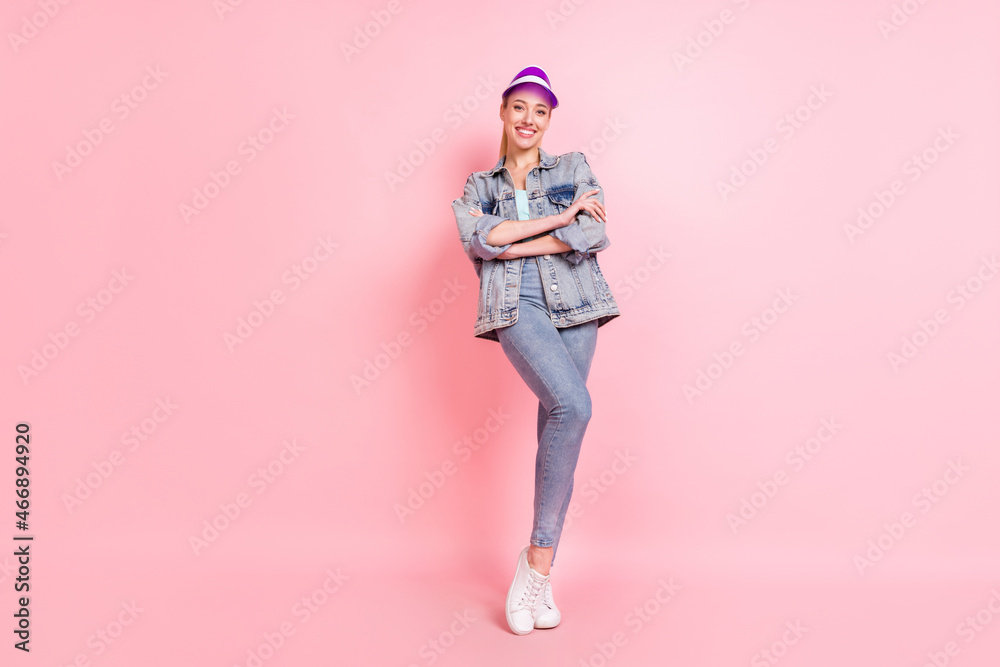 Full body photo of nice blond young lady stand wear jeans jacket visor isolated on pink color background