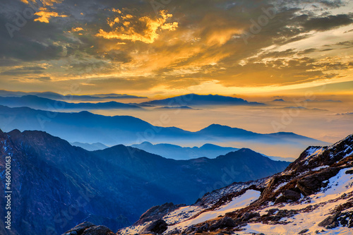 Vivid colorful Himalaya golden orange sunrise over blue mountains at Laurebina La pass, Himalayas, Langtang, Nepal.