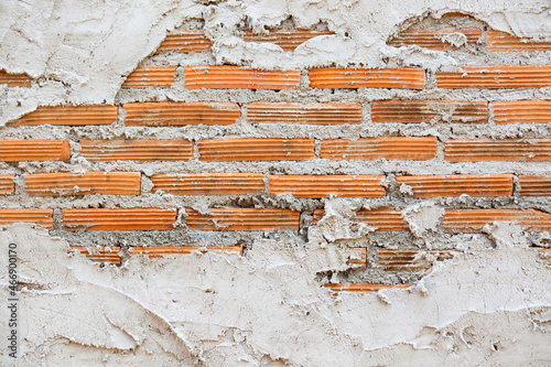 Background Texture of broken or Unfinished Concrete and red Brick Wall