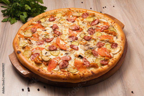 pizza with sausages, cucumbers, tomatoes and mushrooms