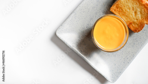 the golden brown toasted bread served with a cup of cheese sauce. a shot of a kind of breakfast menu for western with copy space.