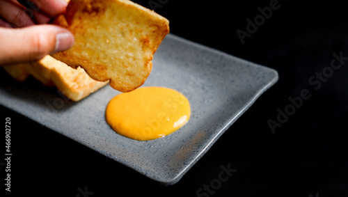 going to put a slice of toasted bread on a cheese sauce. one of the ways to eat food in western ways.