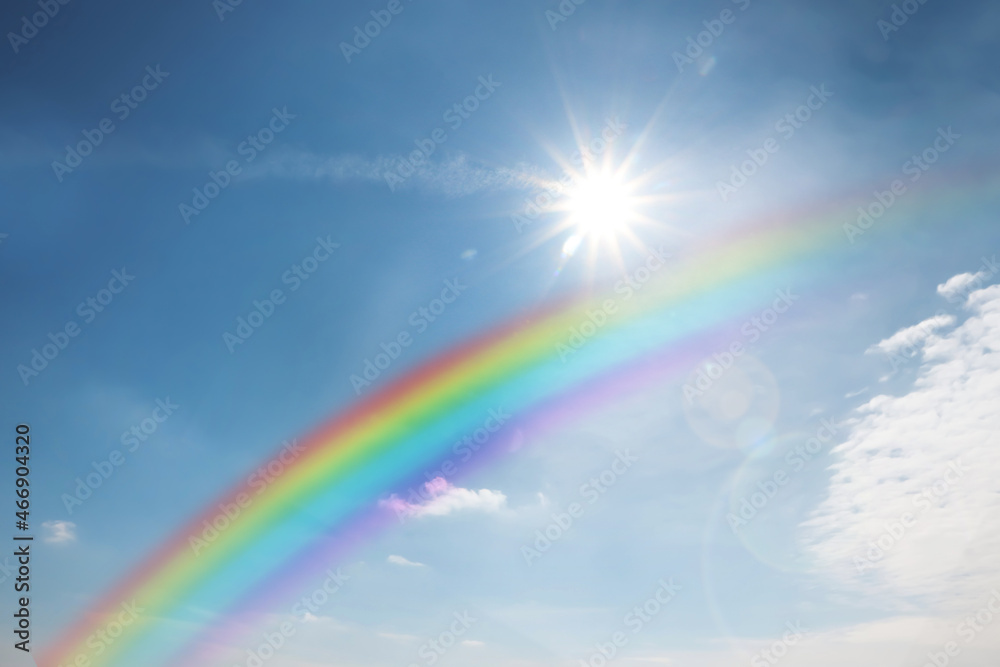 Beautiful rainbow in blue sky with white clouds on sunny day Beautiful rainbow in blue sky with white clouds on sunny day
